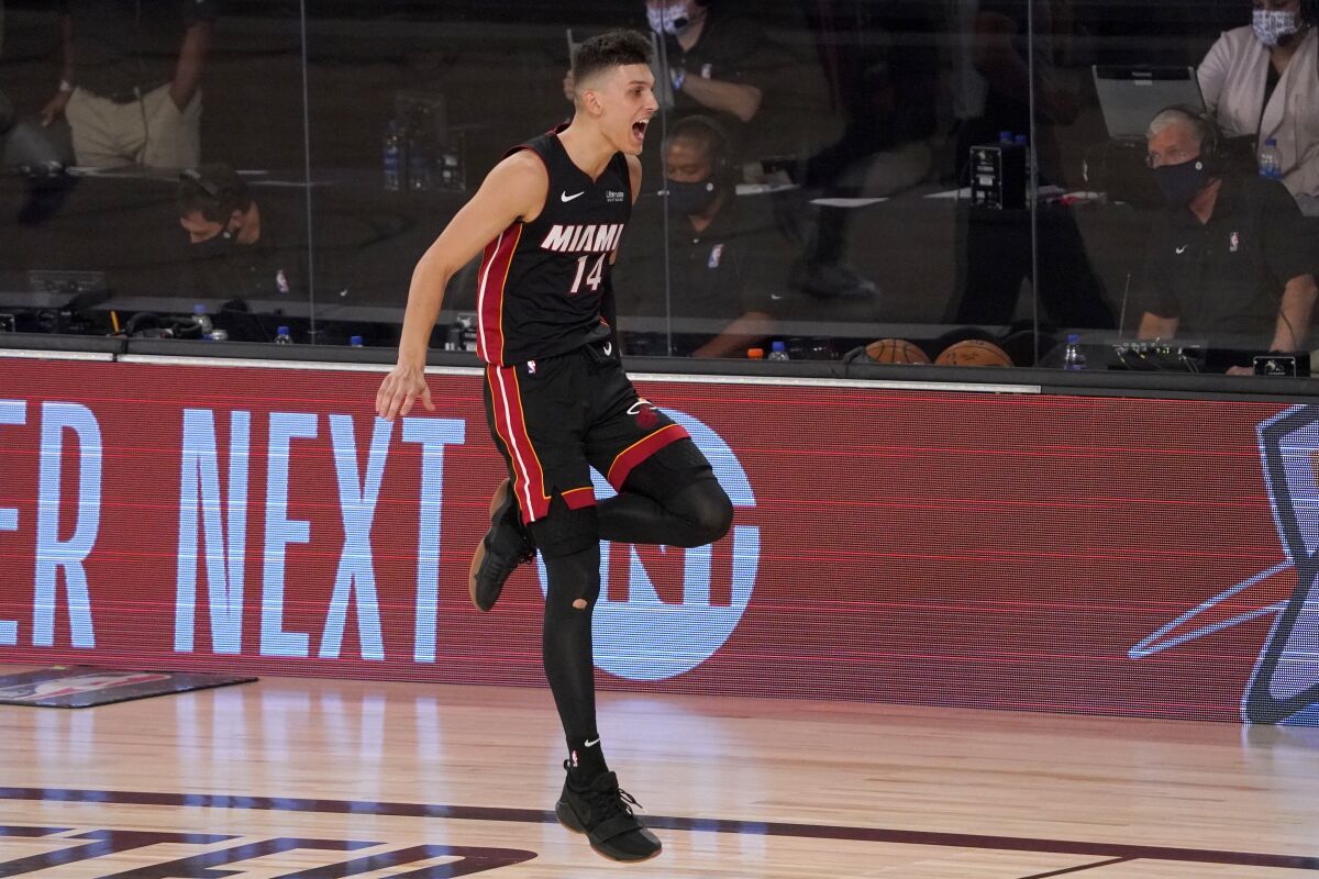 Miami Heat's Tyler Herro (14) celebrates late in the second half of an NBA basketball conference semifinal playoff game against the Milwaukee Bucks on Monday, Aug. 31, 2020, in Lake Buena Vista, Fla. (AP Photo/Mark J. Terrill)