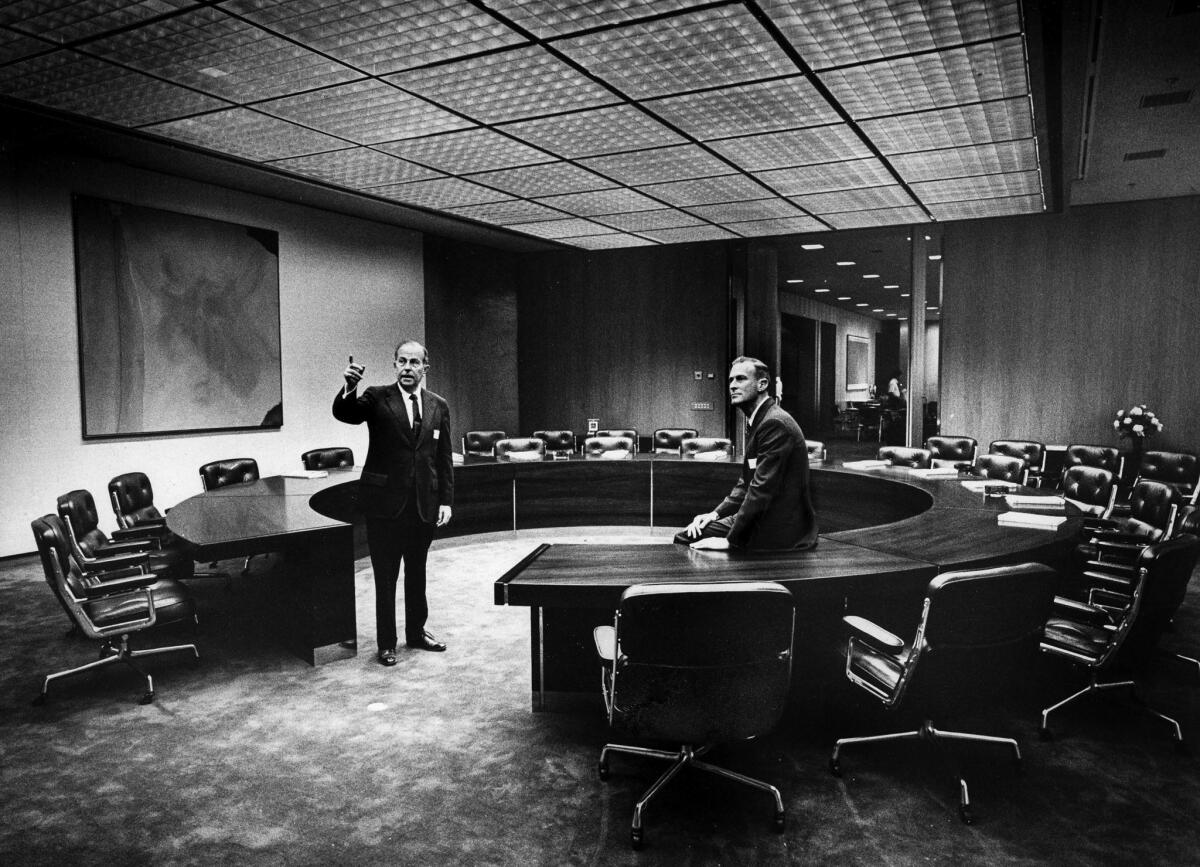 May 22, 1973 -- Dr. Franklin D. Murphy, left, chairman of Times Mirror, shows Dr. Peter S. Bing, a new director, the boardroom in the new corporate headquarters building.
