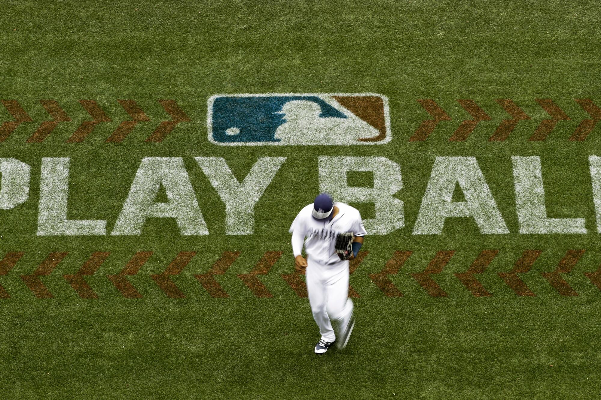 Padres' Allen Cordoba passes a logo on the field for Play Ball, an initiative from MLB and USA Baseball, during a 2017 game.