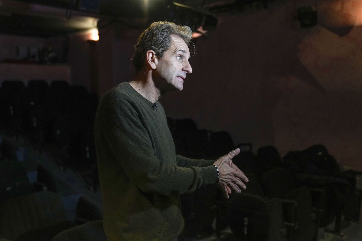 Author and actor Laurent Martinez gestures as he speaks during an interview with The Associated-Press at "Theo Theater" in Paris, Thursday, Oct. 7, 2021. French author and actor Laurent Martinez has been sexually abused by a priest. Over forty years later, he has chosen to make his story a theater play to show the devastating consequences and how speaking out can help overcoming the trauma. The play called "Pardon?" is deeply inspired from the Martinez's own life, describing how he felt devoured from the inside and the difficulties of daily life after being abused. (AP Photo/Michel Euler)