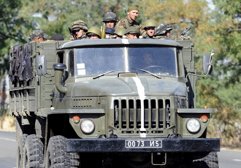 Ukrainian troops head toward the town of Novoazovsk, in the Donetsk region, on Aug. 26.