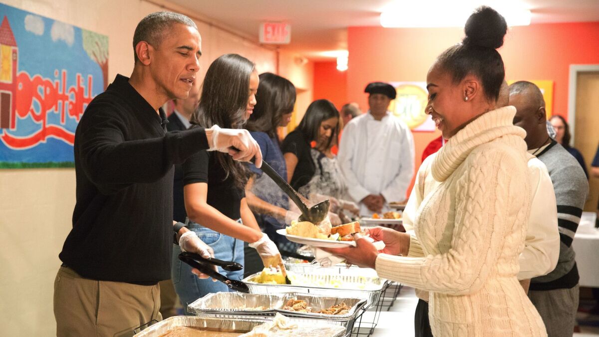 President Barack Obama and family serve Thanksgiving meals to homeless and at-risk veterans at Friendship Place in Washington, D.C. in November 2015.