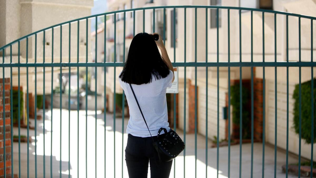 A reporter takes photos of where Hy Soon Oh was murdered the night before, on the 2900 block of Montrose Avenue in La Crescenta on Wednesday, Aug. 9, 2017.