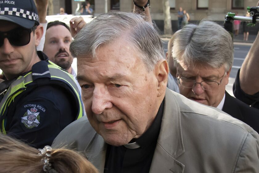 FILE - In this Feb. 27, 2019, file photo, Cardinal George Pell arrives at the County Court in Melbourne, Australia. Pell, Pope Francis' former finance minister, will soon return to the Vatican during an extraordinary economic scandal for the first time since he was cleared of child abuse allegations in Australia five months ago, a newspaper has reported, Monday, Sept. 28, 2020. (AP Photo/Andy Brownbill, File)