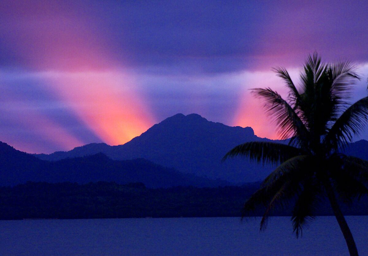 The sun sets behind the mountains of Viti Levu island