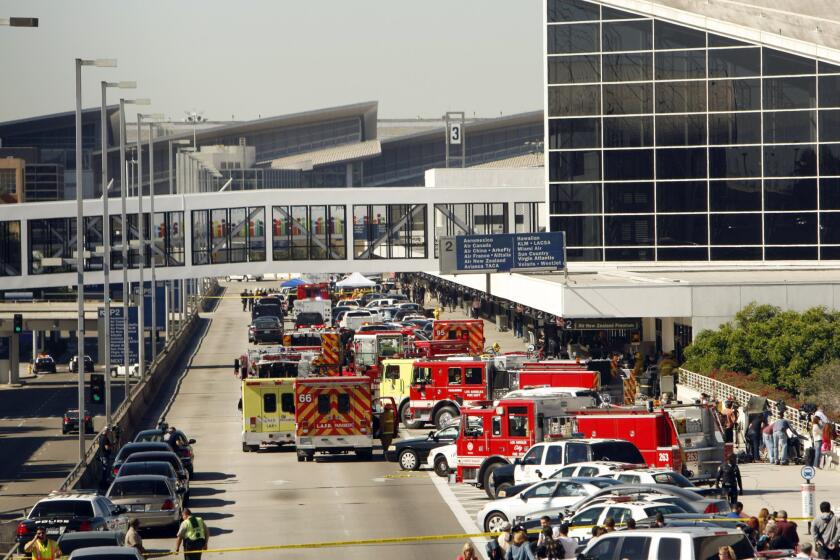 Emergency vehicles line the terminal access road at Los Angeles International Airport after a shooting at Terminal 3 on Nov. 1, 2013. The attack caused widespread chaos, delayed flights and stranded thousands of passengers.