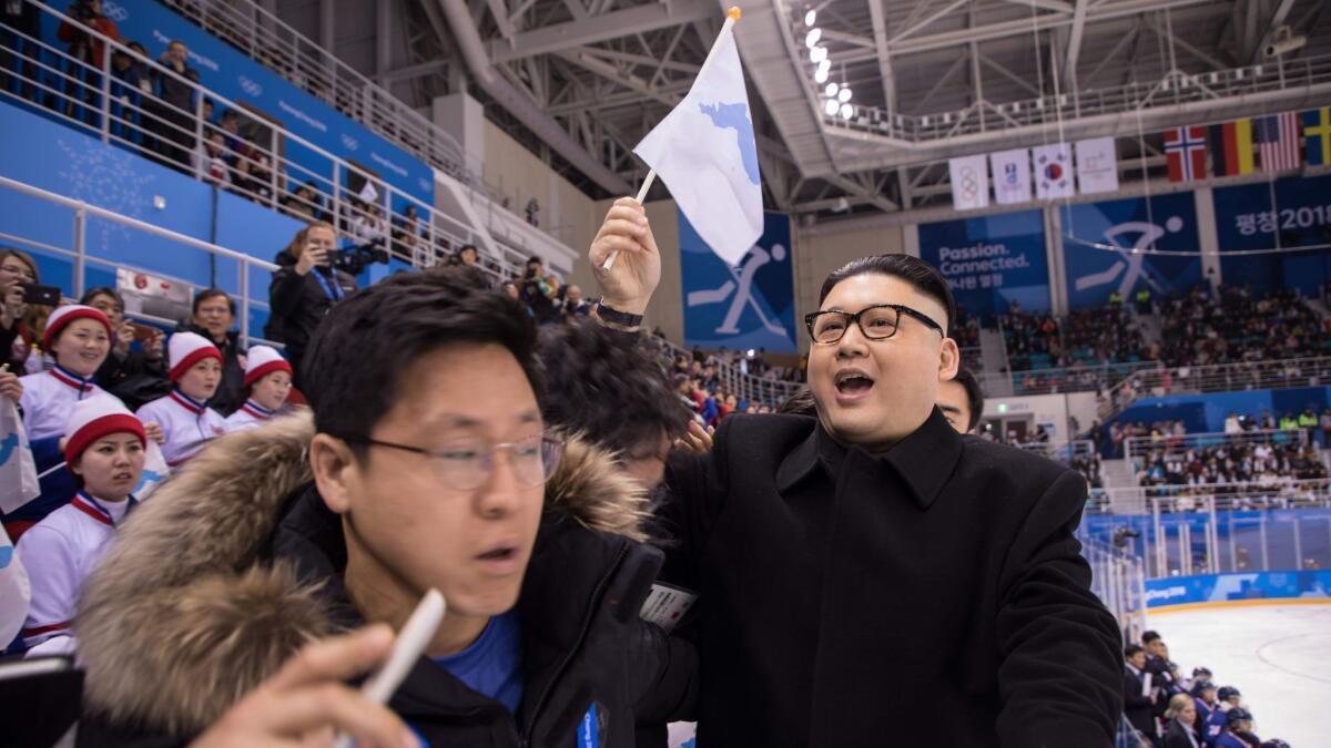 South Korean security guards remove a man impersonating North Korean leader Kim Jong Un from the Unified Korean ice hockey game against Japan in Gangneung, South Korea, on Feb. 14.