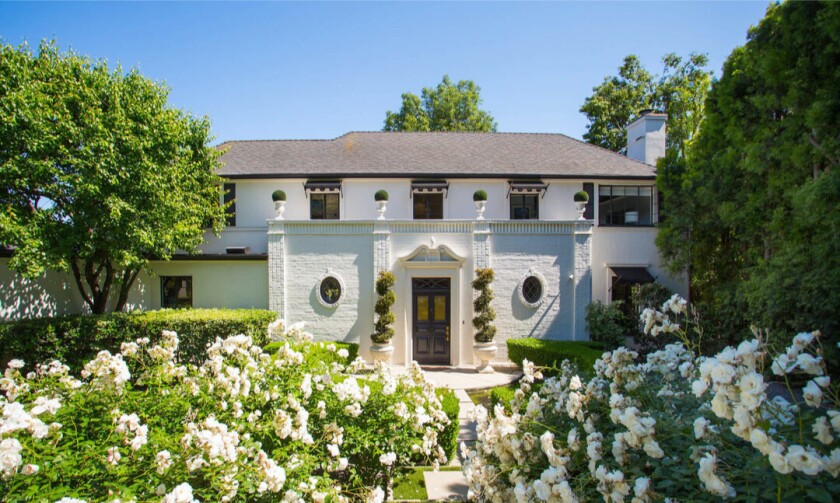 Built in 1936, the elegant Regency-style home showcases dramatic style both inside and out.
