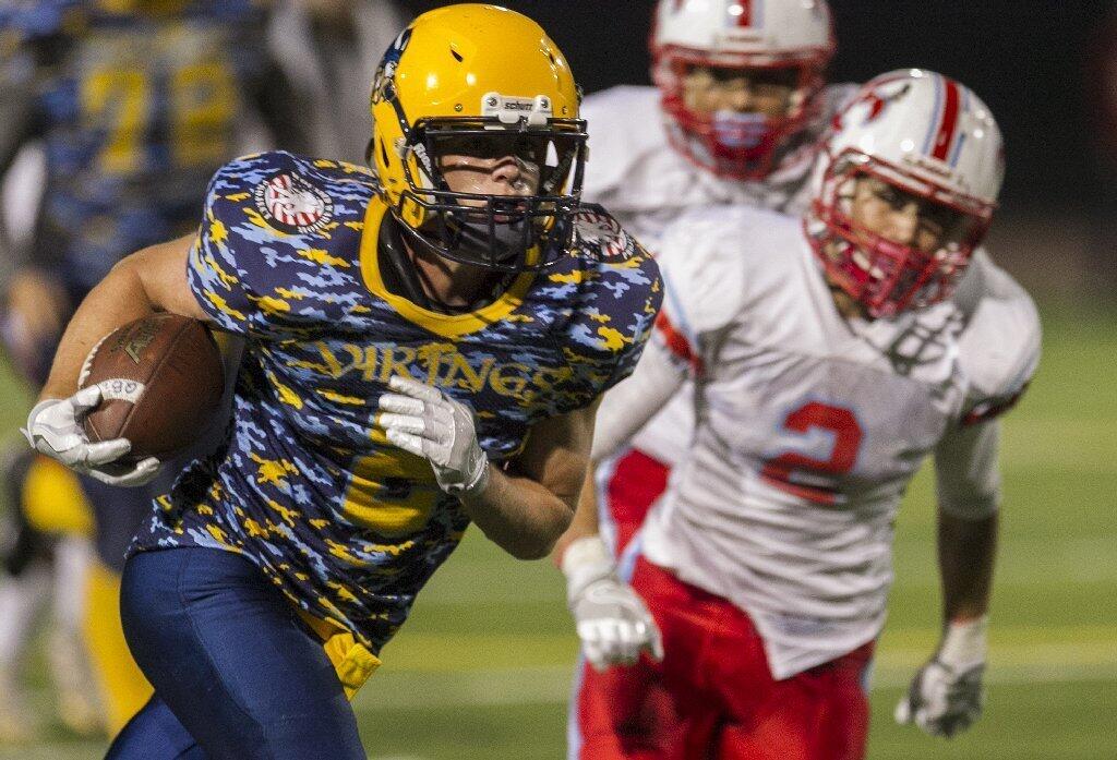 Marina High's Cooper Malerstein runs upfield against Santa Ana's Damian Macias during a game at Westminster High on Thursday.