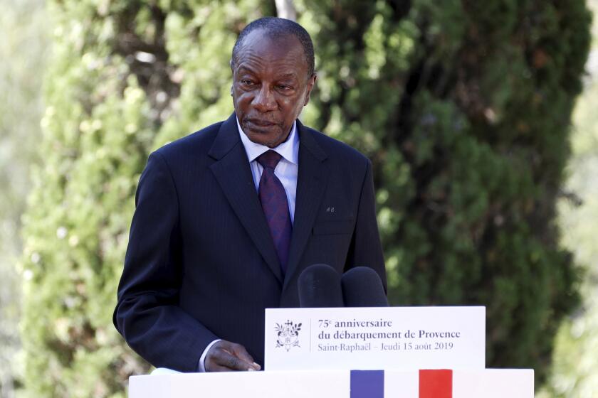 FILE - In this Thursday, Aug. 15, 2019 file photo, Guinean President Alpha Conde delivers a speech during a ceremony marking the 75th anniversary of the WWII Allied landings in Provence, in Saint-Raphael, southern France. Witnesses say heavy gunfire has erupted near the presidential palace in Guinea's capital and went on for hours. It was not immediately known whether President Alpha Conde was home at the time the shooting began. But the gunfire prompted security concerns in the West African country with a long history of coup attempts. (Eric Gaillard/Pool Photo via AP, File)