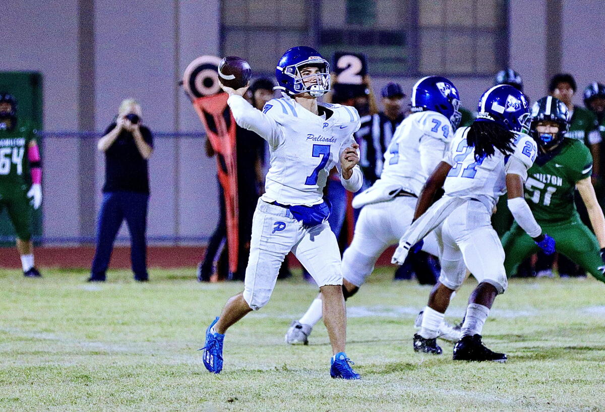 Palisades quarterback Jack Thomas strides forward as he throws a pass from the pocket.