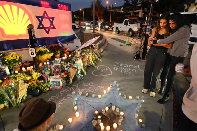 Thousand Oaks, California November 7, 2023-Avia Jacobs, left, and her mother Sharona pay their respects to Paul Kessler , a Jewish supporter, who died after being struck by a Palestinian protestor at the corner of Westlake Blvd. and Thousand Oaks Blvd. in Thousand Oaks. (Wally Skalij/Los Angeles Times)