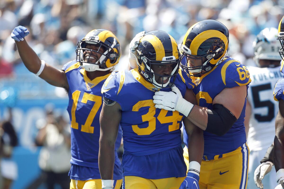 Rams running back Malcolm Brown (34) is congratulated by center Austin Blythe (66) and receiver Robert Woods (17) after scoring a touchdown against the Panthers on Sept. 8.