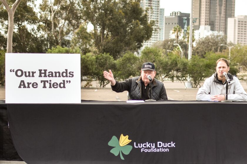 Lucky Duck Foundation executive committee member Dan Shea (left) calls for changes in the city's homeless policies.