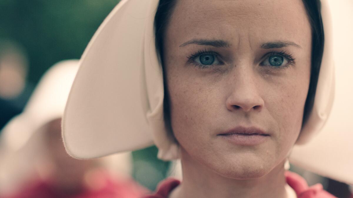 This promotional shot featuring Alexis Bledel depicts the layering of the caplet and wings. (Take Five / Hulu)
