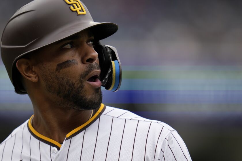 San Diego Padres' Xander Bogaerts looks on as he fouls out while batting during the eighth inning of a baseball game against the Kansas City Royals, Wednesday, May 17, 2023, in San Diego. (AP Photo/Gregory Bull)
