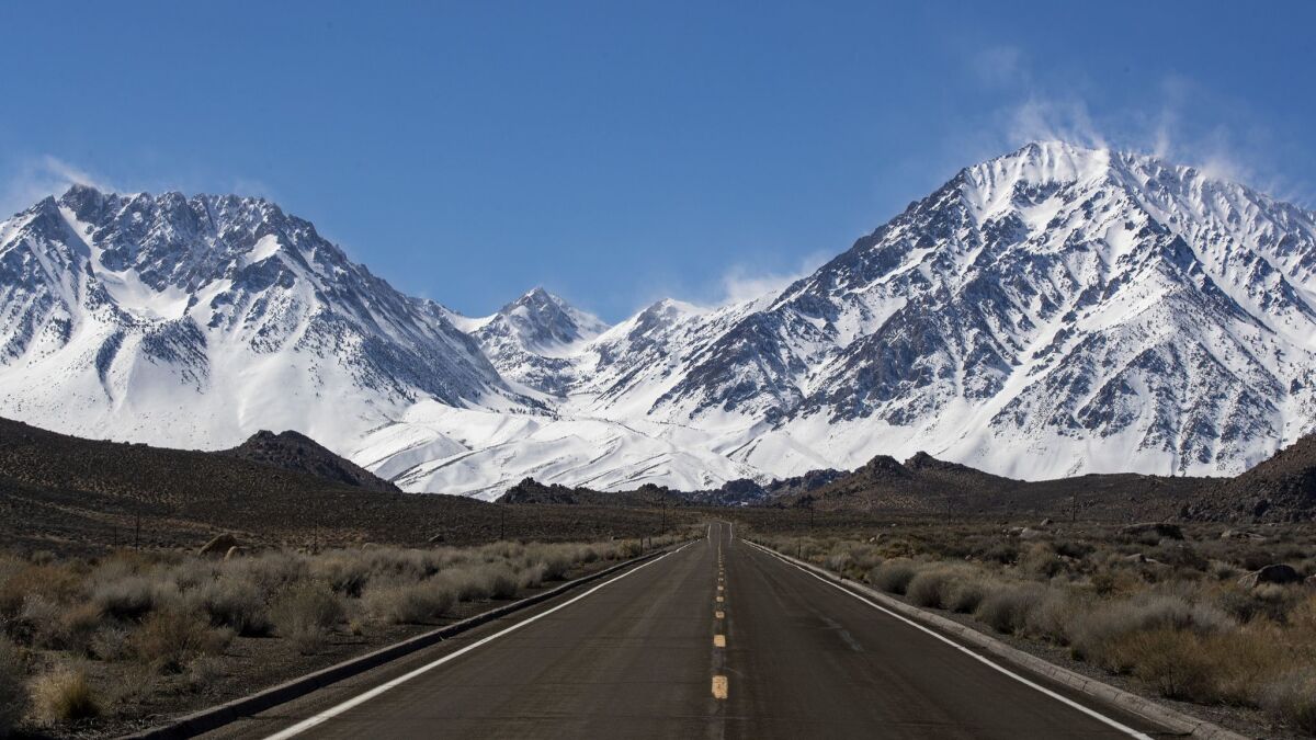 Snow blows from the crest of the Sierra Nevada in a view from Highway 168 near Aspendell, Calif., on March 12.