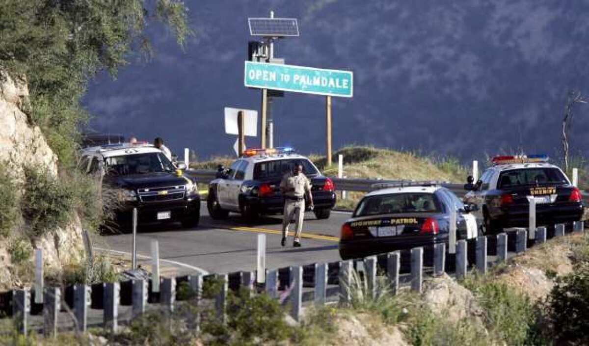 California Highway Patrol and L.A. County Sheriff personnel investigate a reported body on the roadway on Angeles Crest Highway above La Canada Flintridge around mile marker 27.