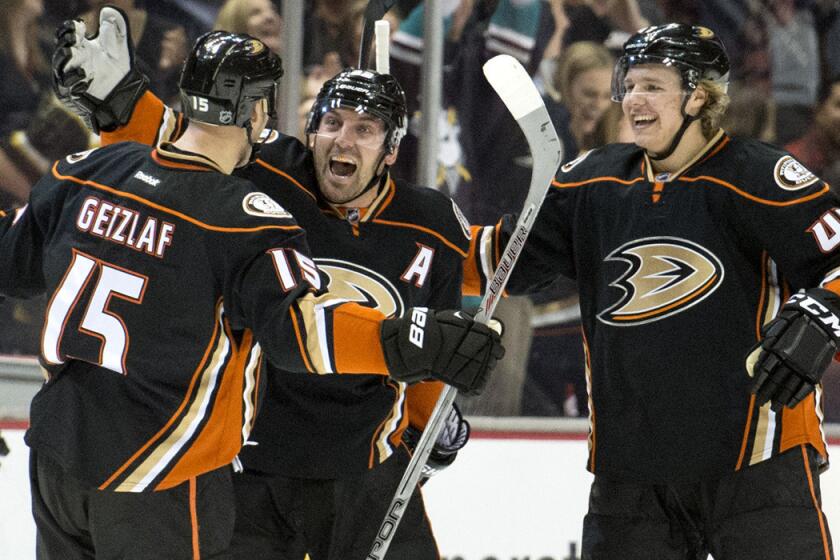 Anaheim Ducks' Francois Beauchemin, center, celebrates his goal against the Detroit Red Wings with Ryan Getzlaf, left, and Hampus Lindholm on Feb. 23.