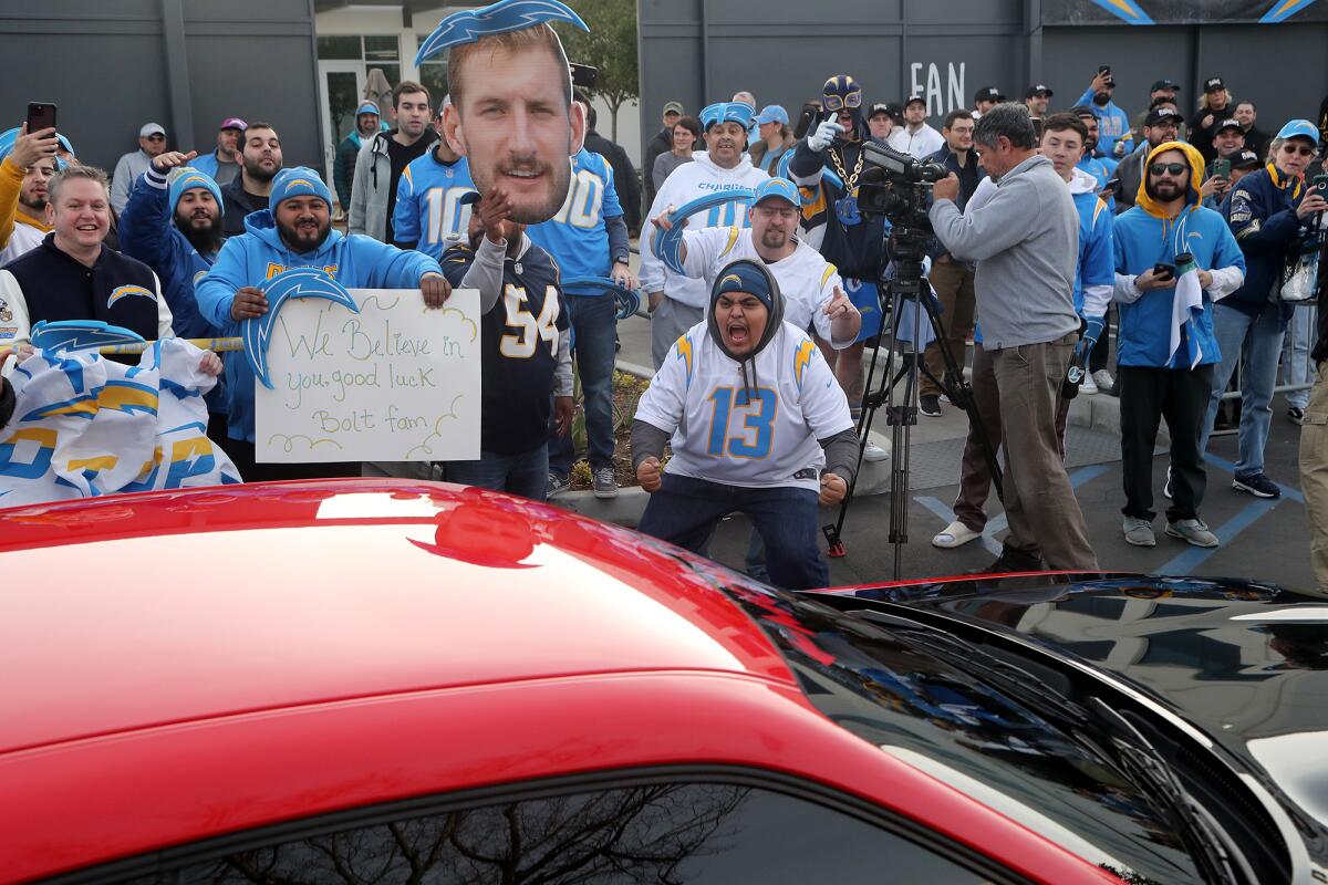 Fans voice their support as Los Angeles Chargers players arrive at Hoag Performance Center in Costa Mesa on Friday morning.
