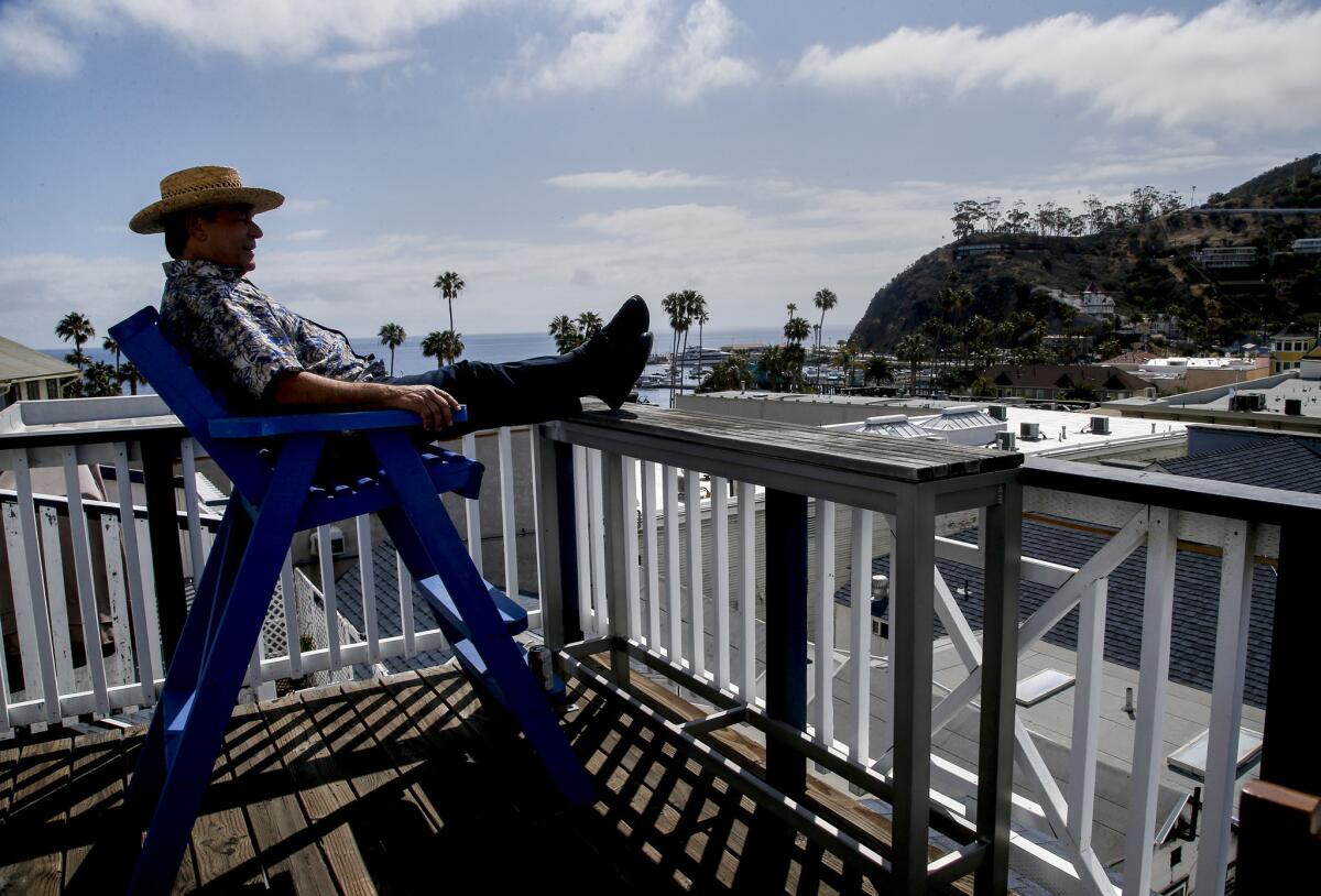 Mark Malan, owner of the Hermosa Hotel in Avalon, sits on the balcony of his suite, talking about his effort to create the first medicinal pot dispensary in the resort community of Avalon