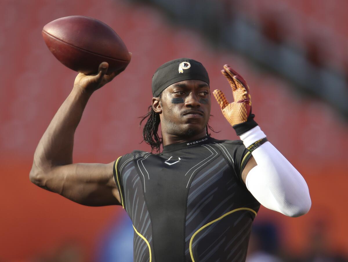 Robert Griffin III warms up with the Washington Redskins before a preseason game against the Cleveland Browns on Aug. 13.