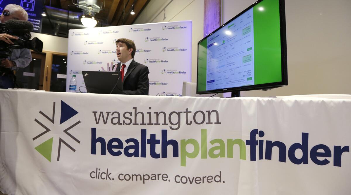 Brad Finnegan demonstrates the Washington Healthplanfinder website, which allows consumers to compare and purchase health insurance plans and to see if they are eligible for government subsidies.