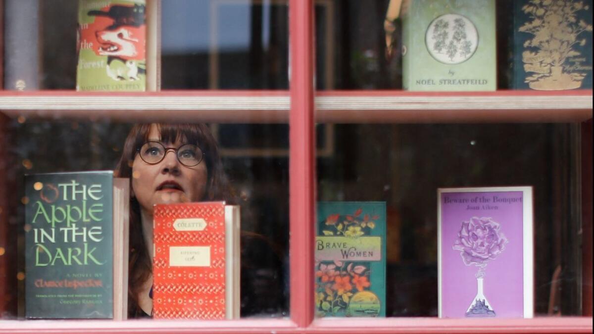 A.N. Devers, author, rare-book dealer and owner of the Second Shelf, poses in her bookshop in London in March.
