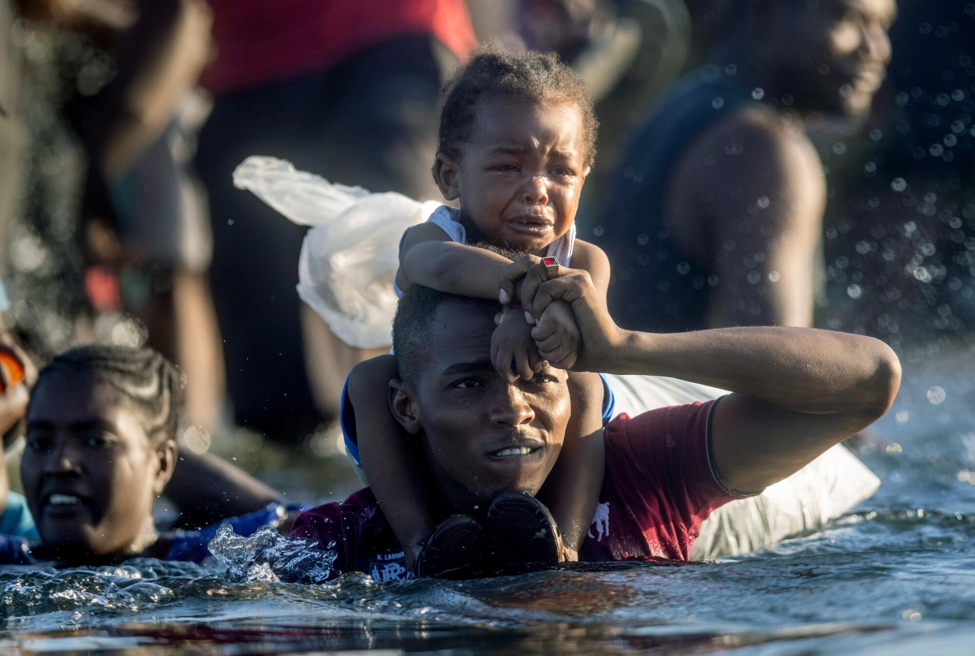 Haitian immigrants cross the Rio Grande from Del Rio, Texas.