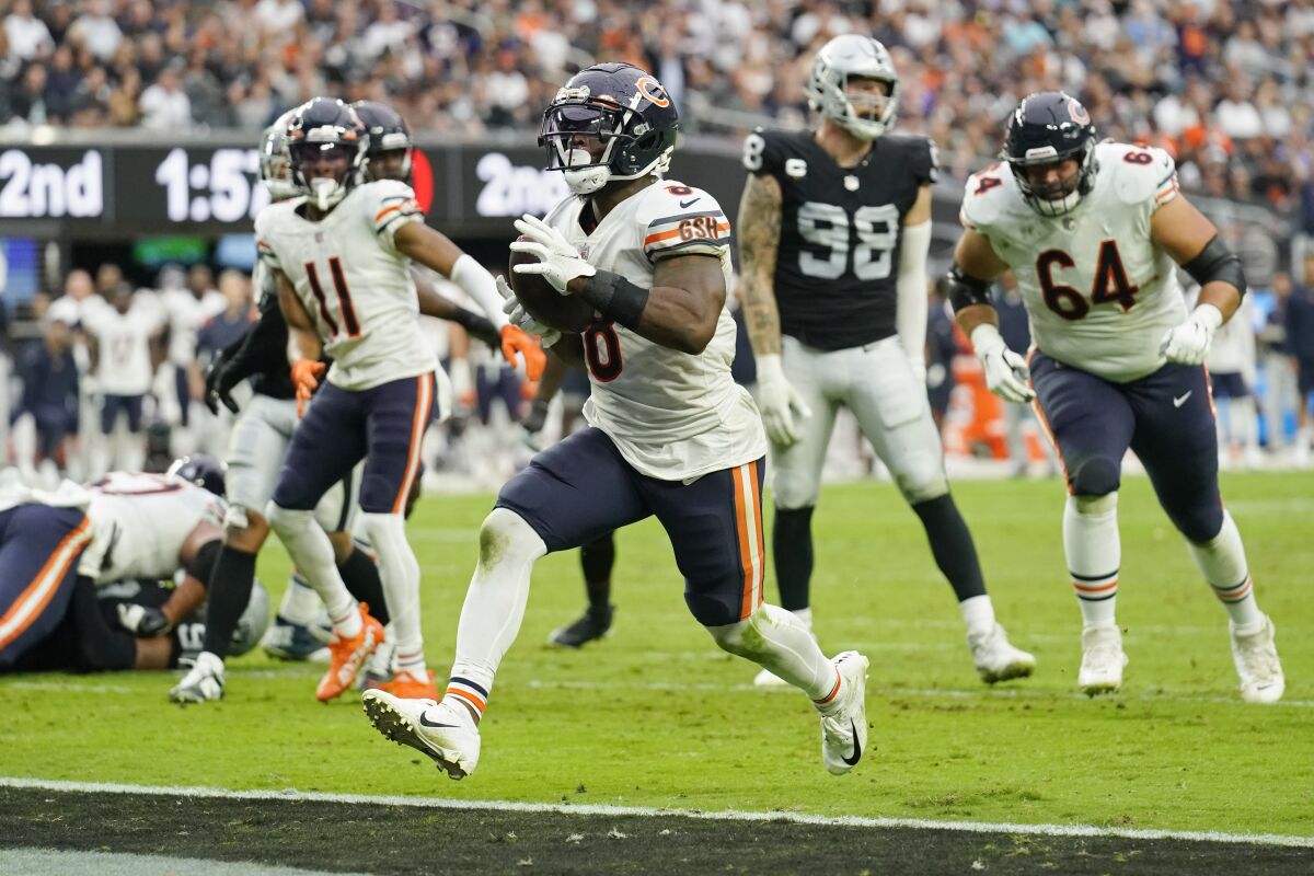 Chicago Bears running back Damien Williams (8) scores a touchdown against the Las Vegas Raiders during the first half of an NFL football game, Sunday, Oct. 10, 2021, in Las Vegas. (AP Photo/Rick Scuteri)