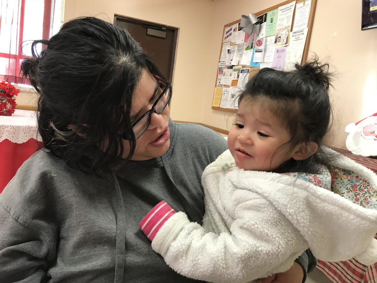 Gabriela Gutierrez, 32, and daughter Genesis take refuge from the Thomas fire after her home burned.