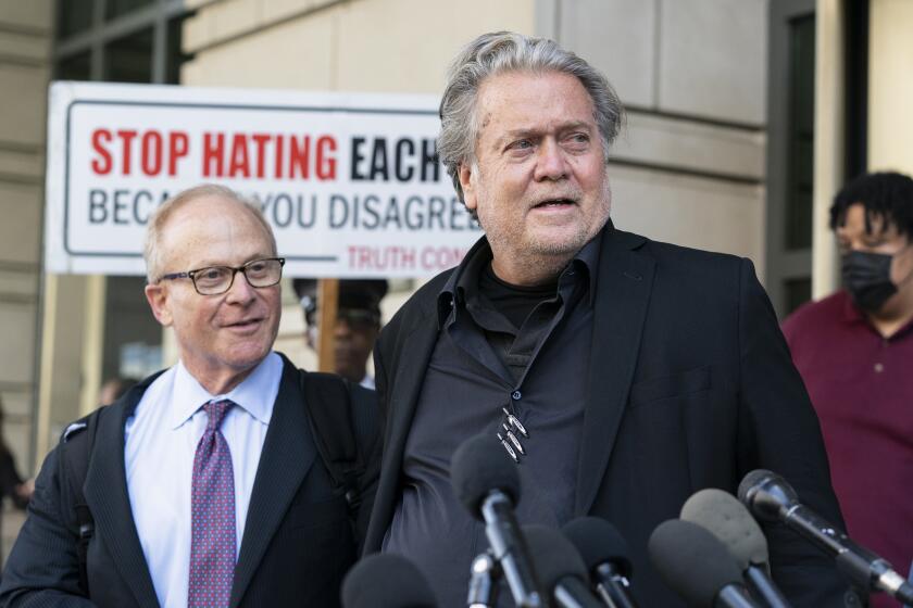Former White House strategist Steve Bannon, right, walks to speak with reporters as he departs federal court on Friday, July 22, 2022, in Washington. Accompanying Bannon are his attorney David Schoen. Bannon, a one-time adviser to former President Donald Trump, was found guilty of criminal contempt of Congress charges after refusing for months to cooperate with the House committee investigating the Jan. 6, 2021, Capitol insurrection. (AP Photo/Alex Brandon)
