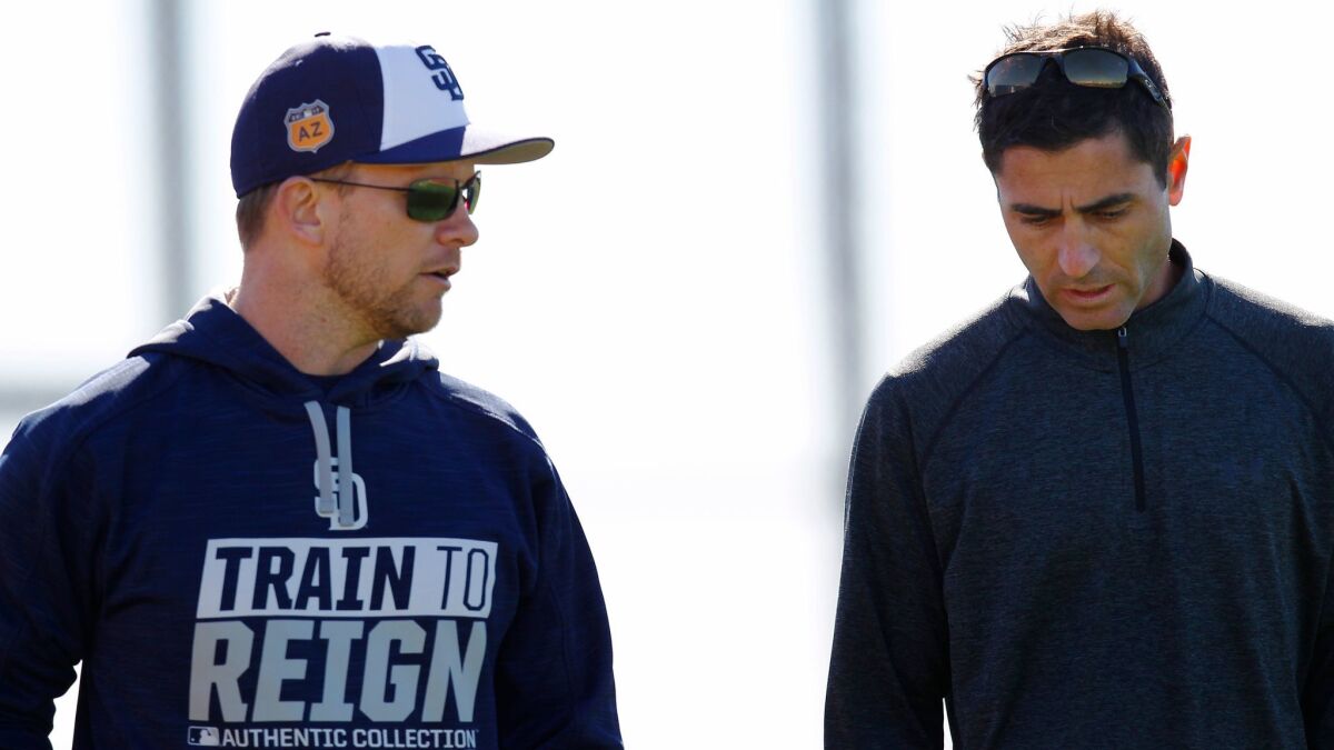 San Diego Padres manager Andy Green and General Manager A.J. Preller walk to the clubhouse after a spring training practice.