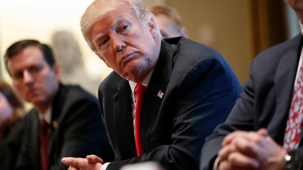 President Trump listens during a meeting with steel and aluminum executives in the Cabinet Room of the White House on March 1.