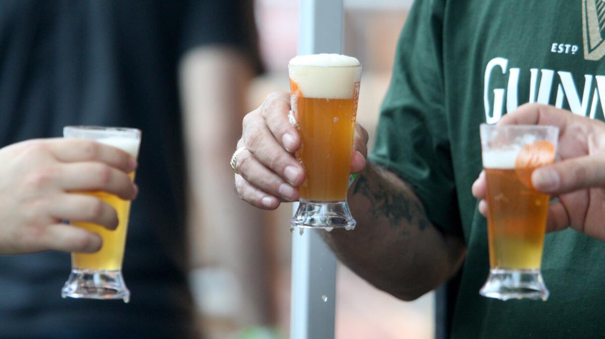 Festivalgoers sample the Pacific Coast Hopliner IPA at the Burbank Beer Festival, in this file photo taken on Saturday, Oct. 17, 2015.