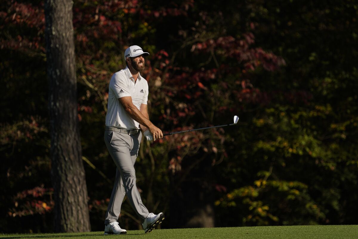 Dustin Johnson watches his second shot on the 11th hole during the third round of the Masters golf tournament Saturday, Nov. 14, 2020, in Augusta, Ga. (AP Photo/David J. Phillip)