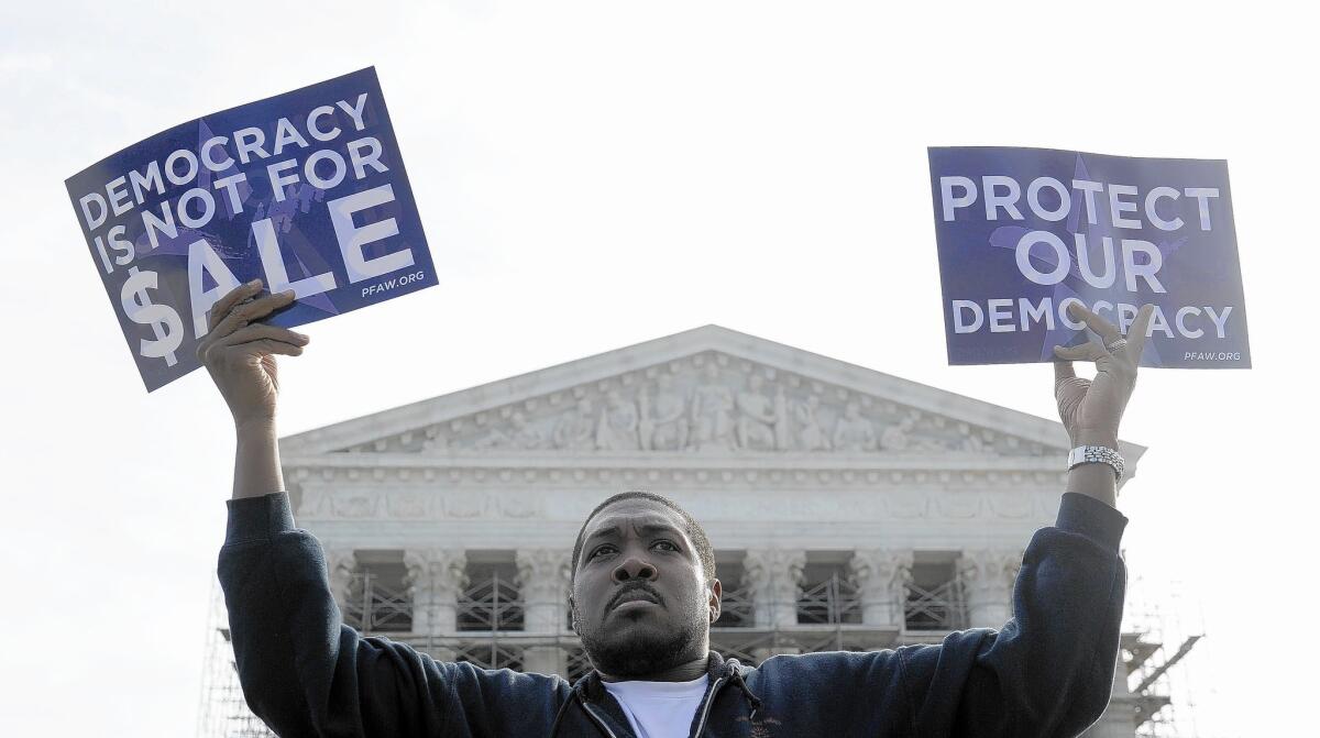 Cornell Woolridge of Windsor Mill, Md., takes part in a demonstration outside the Supreme Court in Washington as the court heard arguments on campaign finance in October.