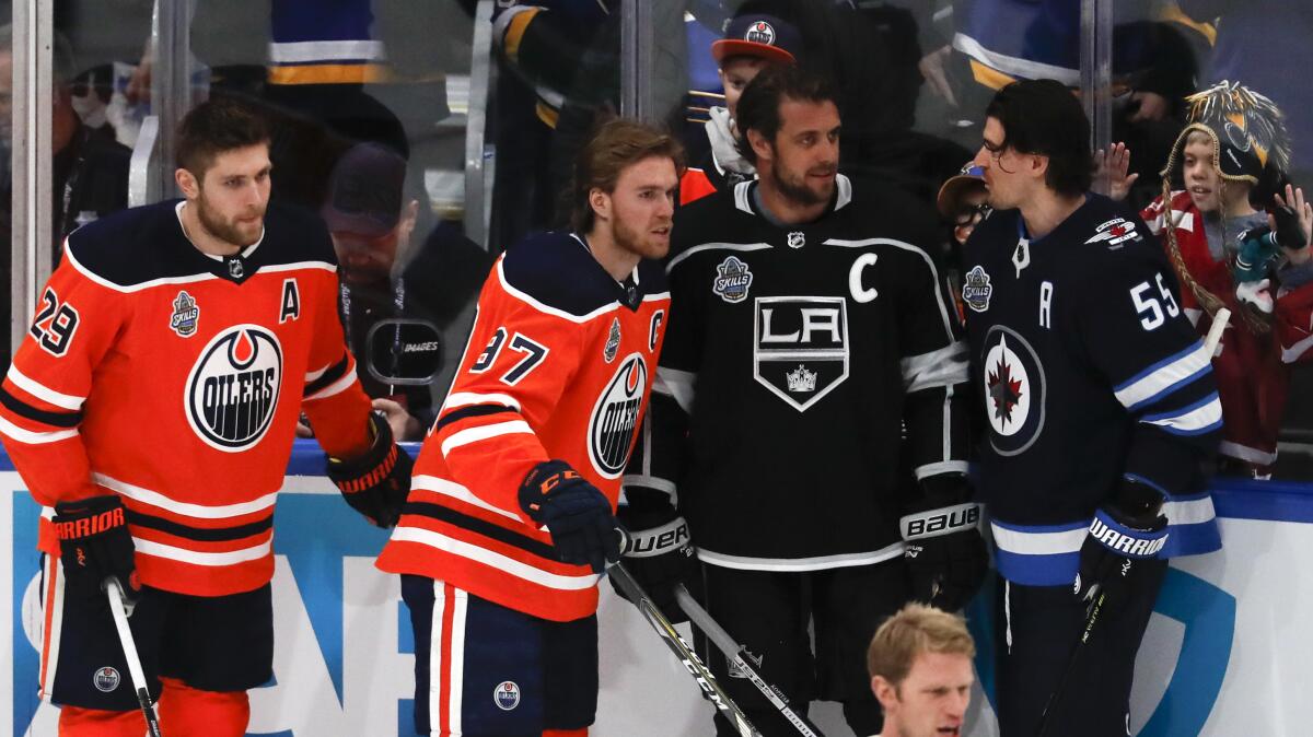 The Kings' Anze Kopitar, second from right, chats with fellow players before the NHL All-Star skills event Jan. 24, 2020.