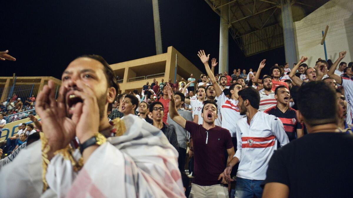 Zamalek soccer fans cheer their team during the first stadium match in six years.