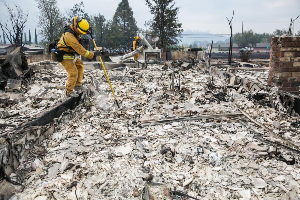 Firefighters look for hotspots on Sept. 14 after the Valley fire destroyed homes in Middletown, Calif.