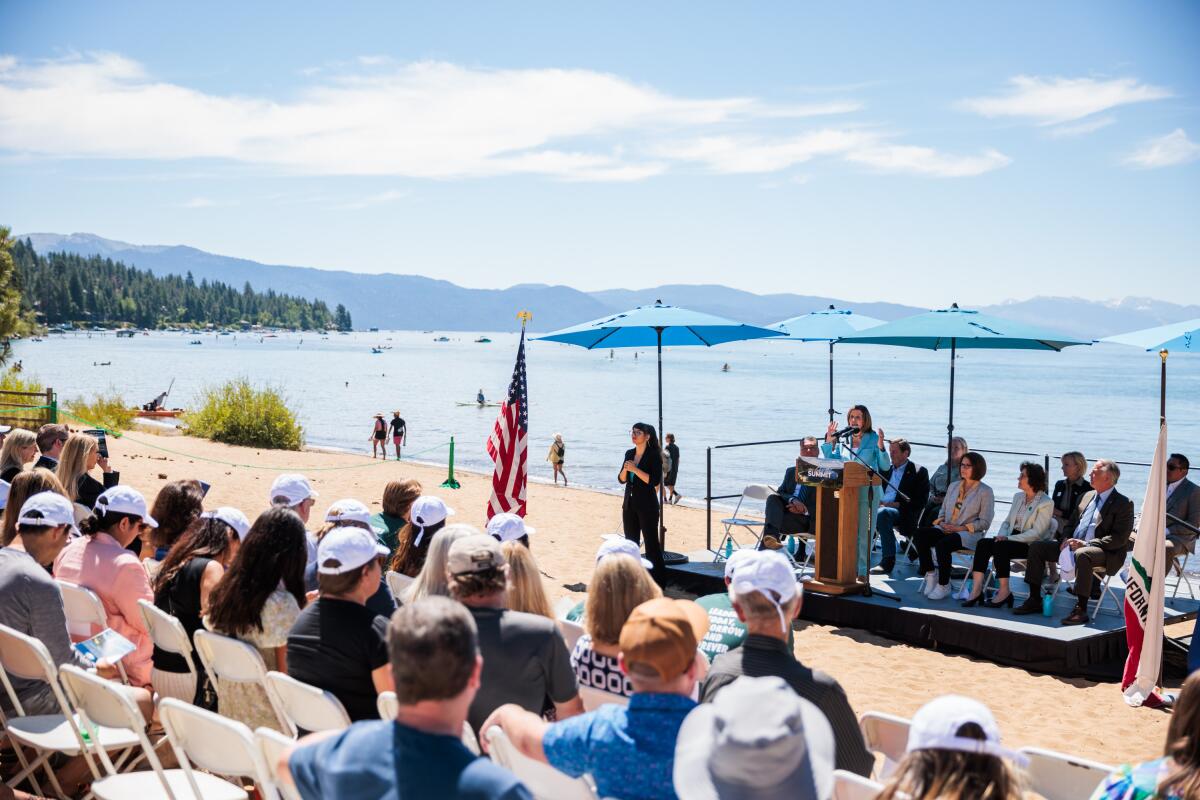 Rep. Nancy Pelosi giving a speech on the shores of Lake Tahoe.