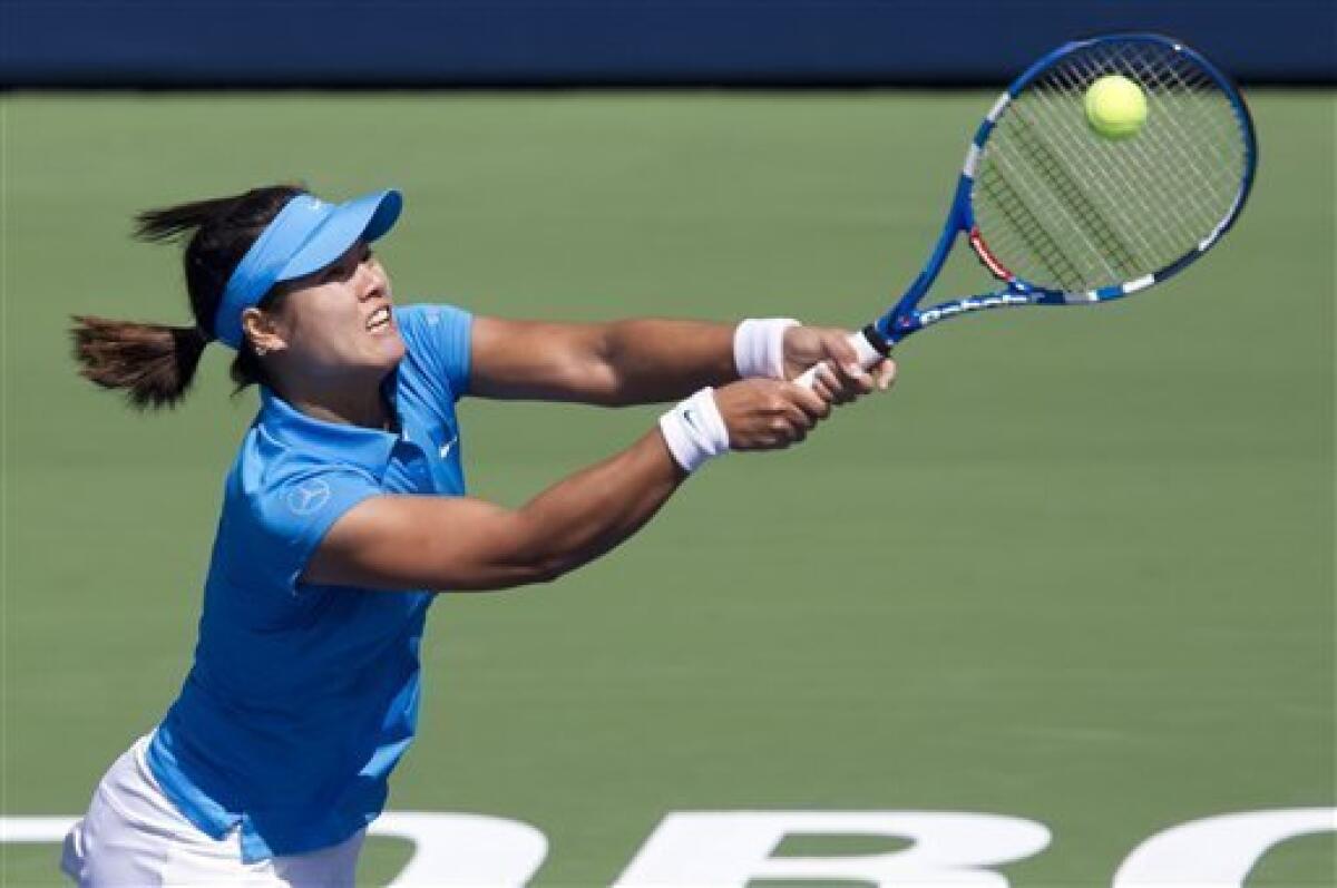 Li Na, of China, hits a return during her match against Samantha Stosur, of Australia, at the Rogers Cup women's tennis tournament in Toronto Thursday, Aug. 11, 2011. (AP Photo/The Canadian Press, Darren Calabrese)