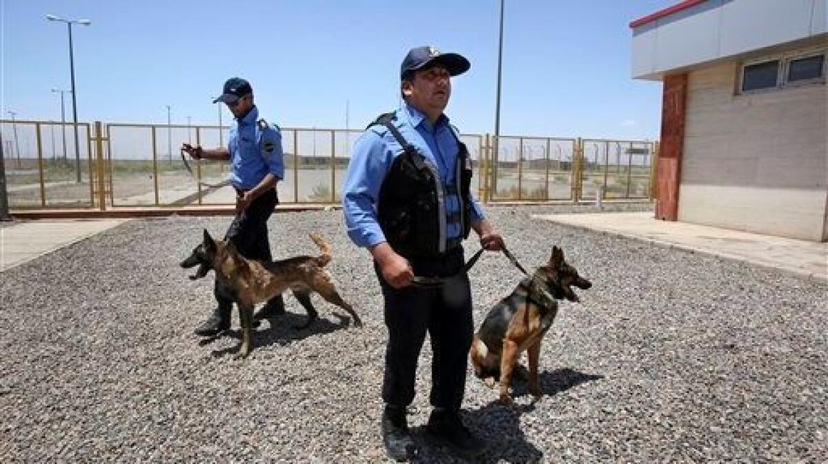 Iranian customs officers with drug-sniffing dogs at a customs house on the Afghanistan border in 2014.