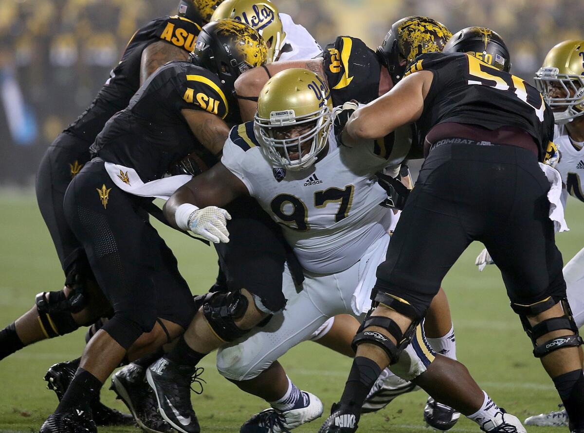 UCLA defensive lineman Kenny Clark breaks through the Arizona State offensive line during the Bruins' 62-27 win over the Sun Devils. The Bruins have recorded just four sacks this season.