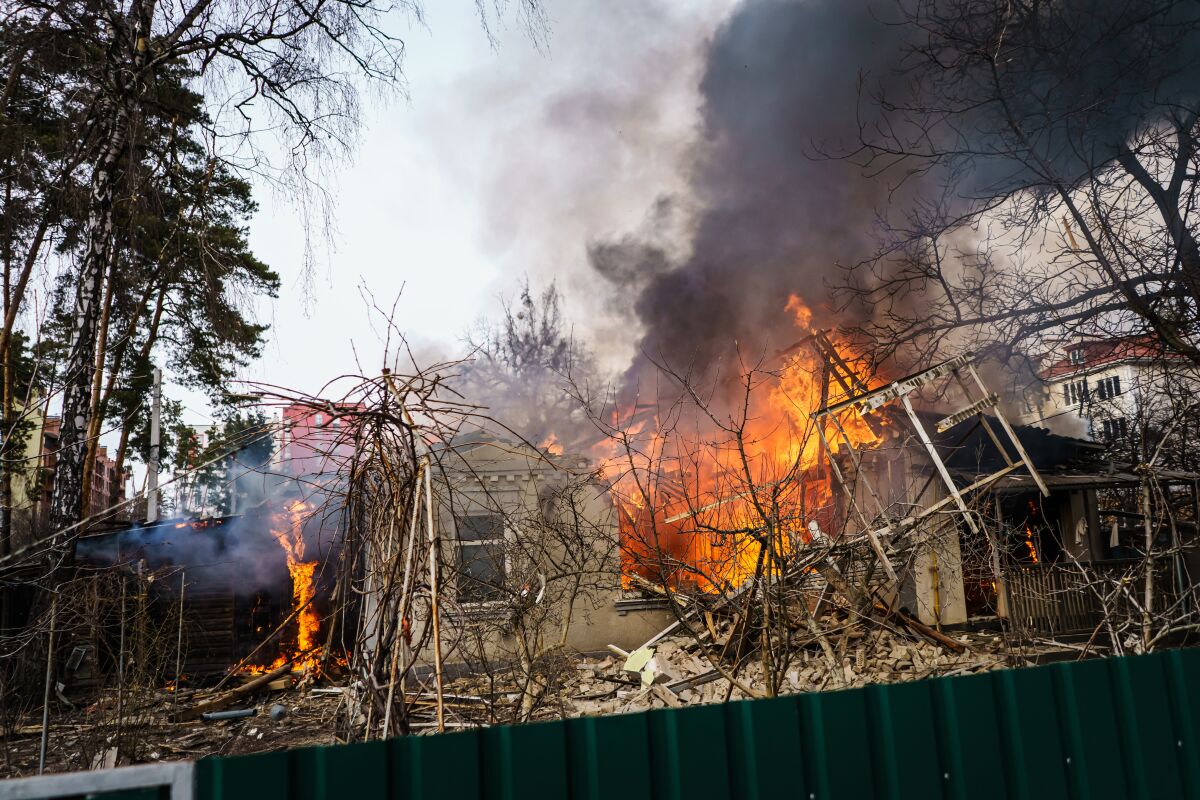 A home caught fire after it was damaged by Russian bombardment Saturday in Irpin.