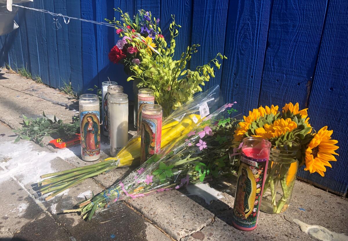 Candles, flowers and balloons were left behind where a 14-year-old boy was fatally shot in City Heights on Sunday afternoon.
