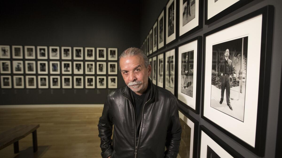 Harry Gamboa Jr. with his portrait collection "Chicano Male Unbonded."