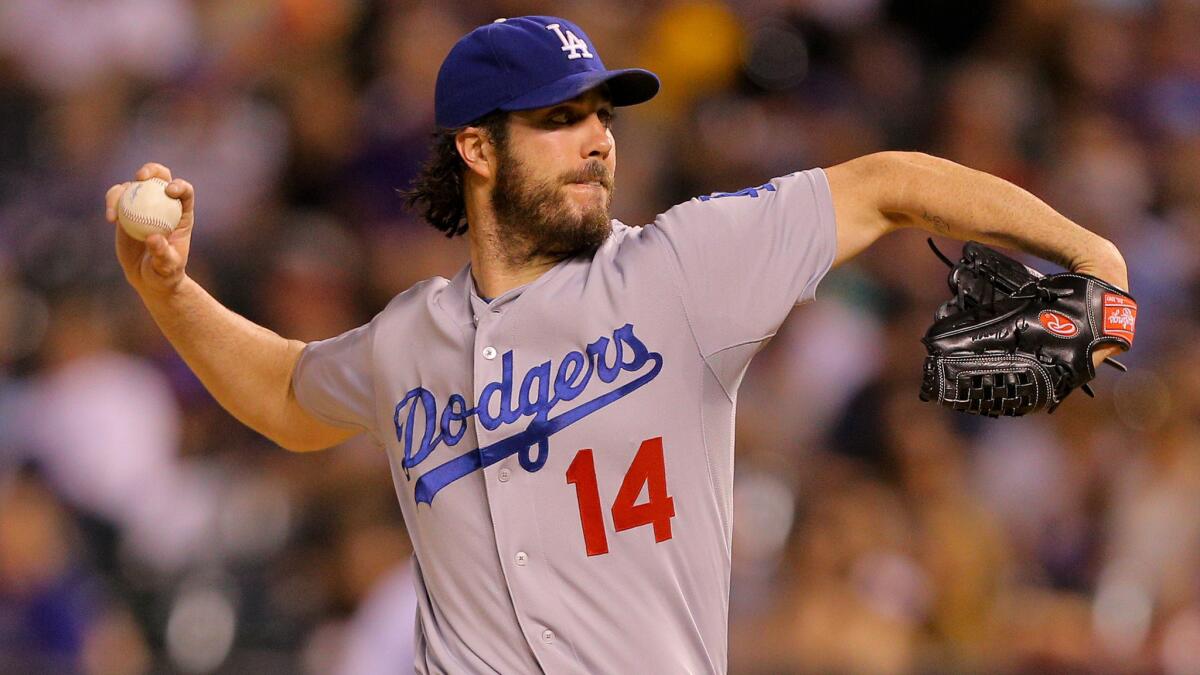 Dodgers starter Dan Haren delivers a pitch during the third inning of a 10-4 loss to the Colorado Rockies on Sept. 16.