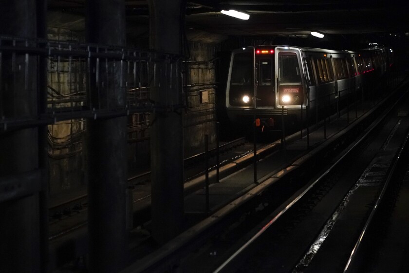 A Washington Metro train pulls into Dupont Circle station, Wednesday, Nov. 24, 2021, in Washington. The regional train system serving the District of Columbia area will remain on drastically reduced service levels through at least the end of this year, as authorities grapple with a safety problem that has forced the majority of the trains out of service. (AP Photo/Patrick Semansky)