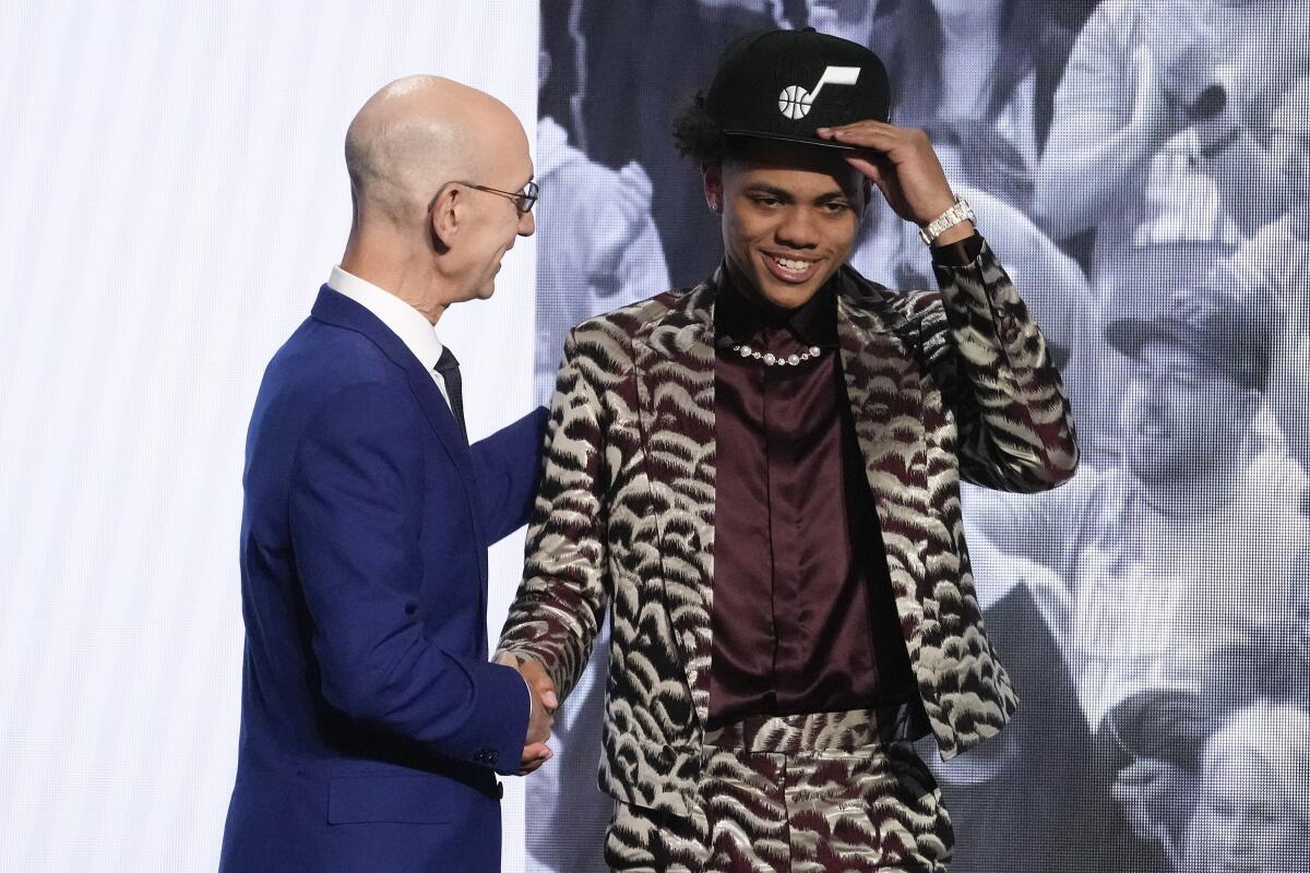 Keyonte George is greeted by NBA Commissioner Adam Silver after being selected 16th overall by the Utah Jazz.